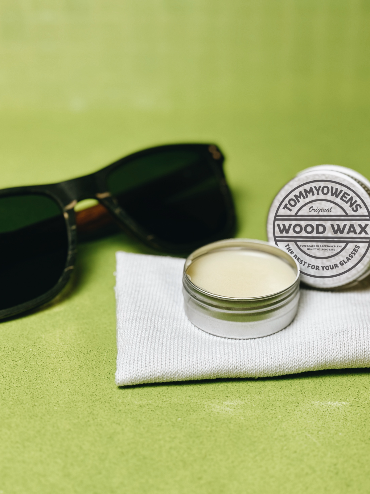 Applying beeswax to condition wooden sunglasses frames.