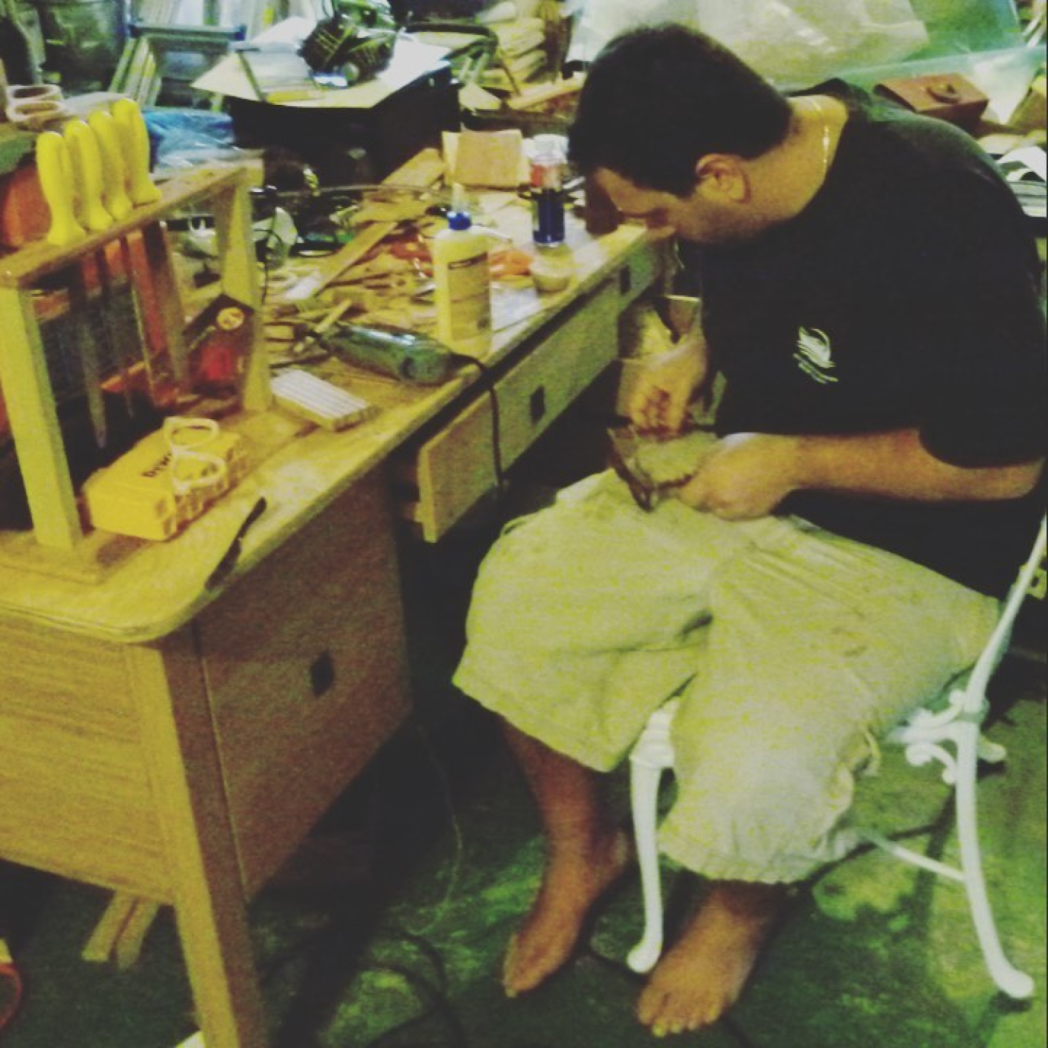 Tommy Owens, founder, handcrafting a pair of wooden sunglasses in his garage during the early days of the company.