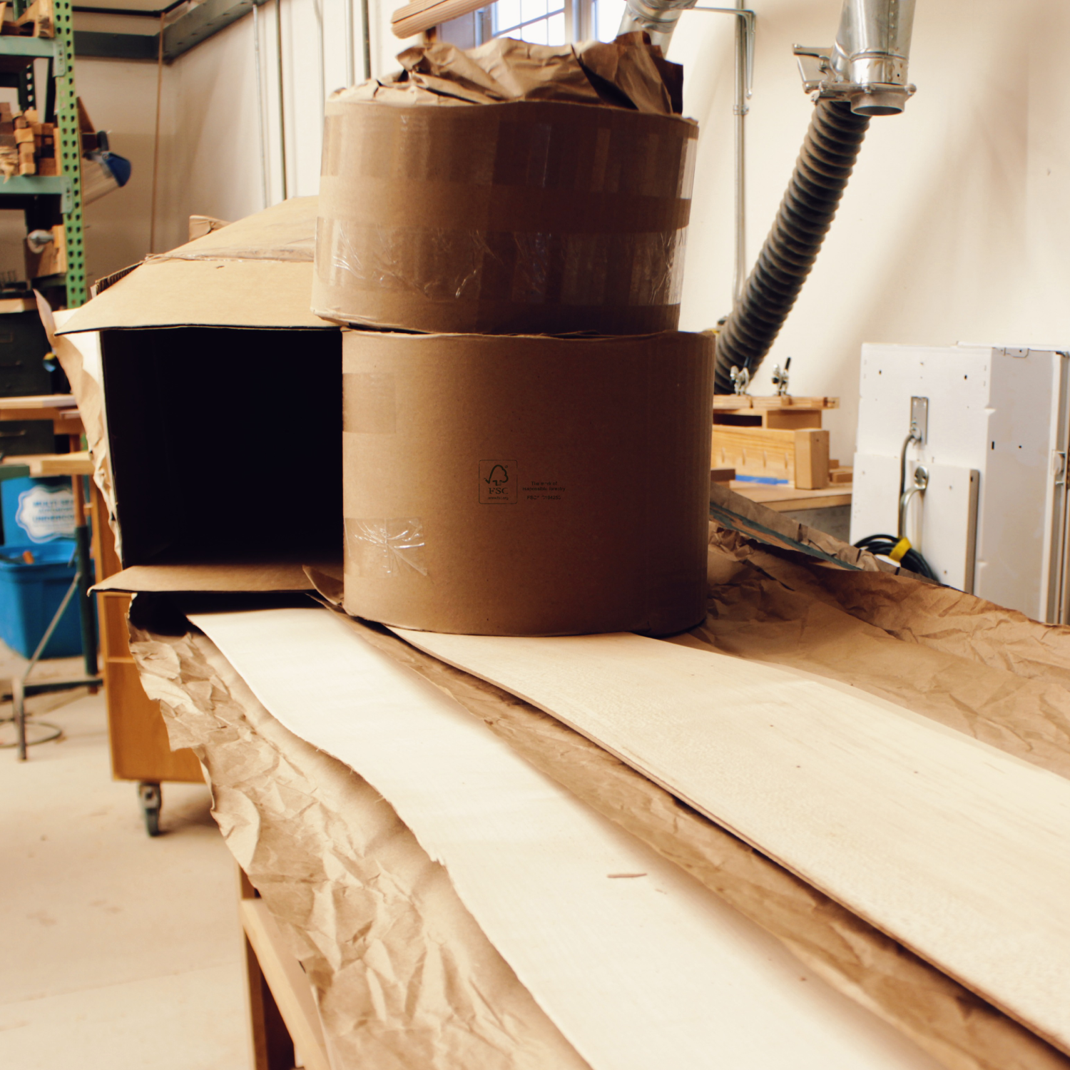 Unpacking sustainably sourced FSC-certified maple veneer at the Tommy Owens Eyewear workshop, used to create their signature wooden sunglasses.