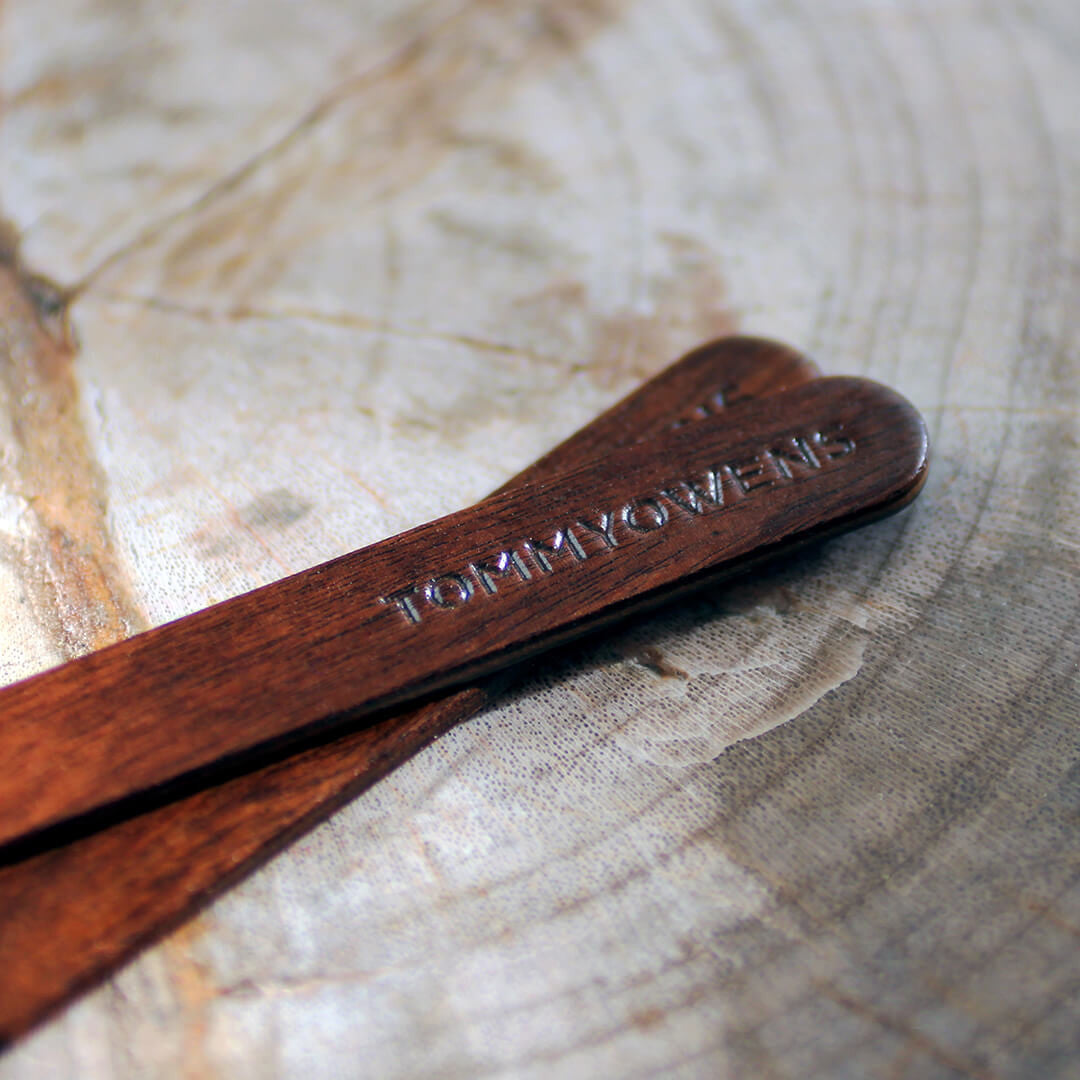 Rosewood collar stays scattered amongst dried leaves, reflecting their natural origins and earthy tones.