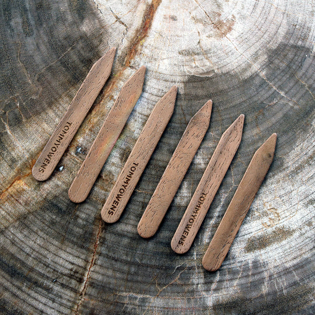 6 handcrafted walnut collar stays, showcasing the rich, dark wood grain and polished finish. A luxurious touch for any dress shirt.